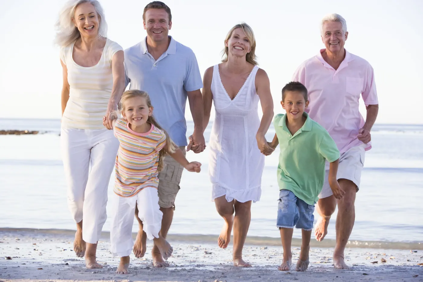 Extended family walking on the beach